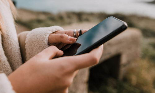 A close-up of a woman texting on her phone.